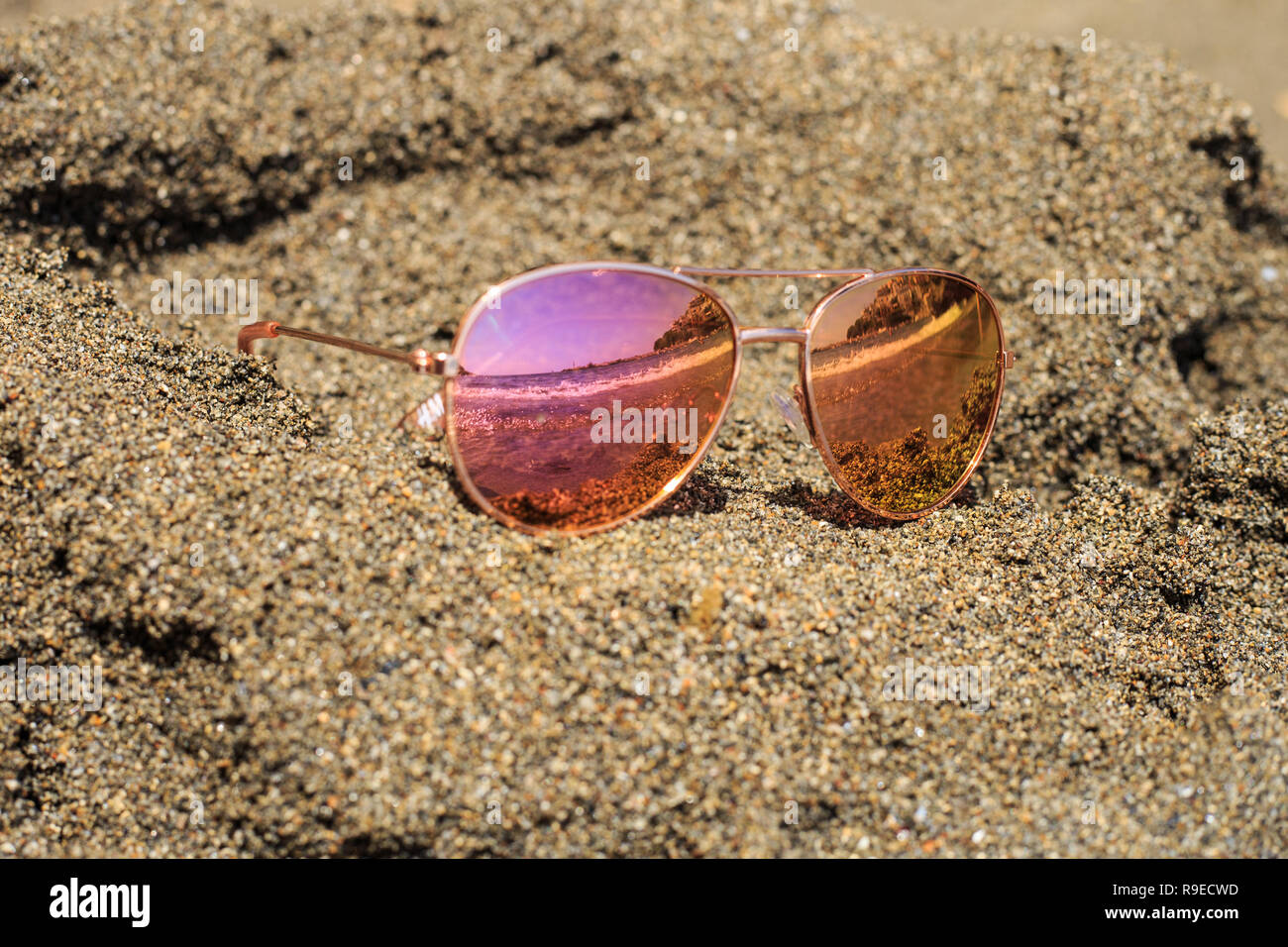 Sunglasses at the beach with sea reflection Stock Photo Alamy