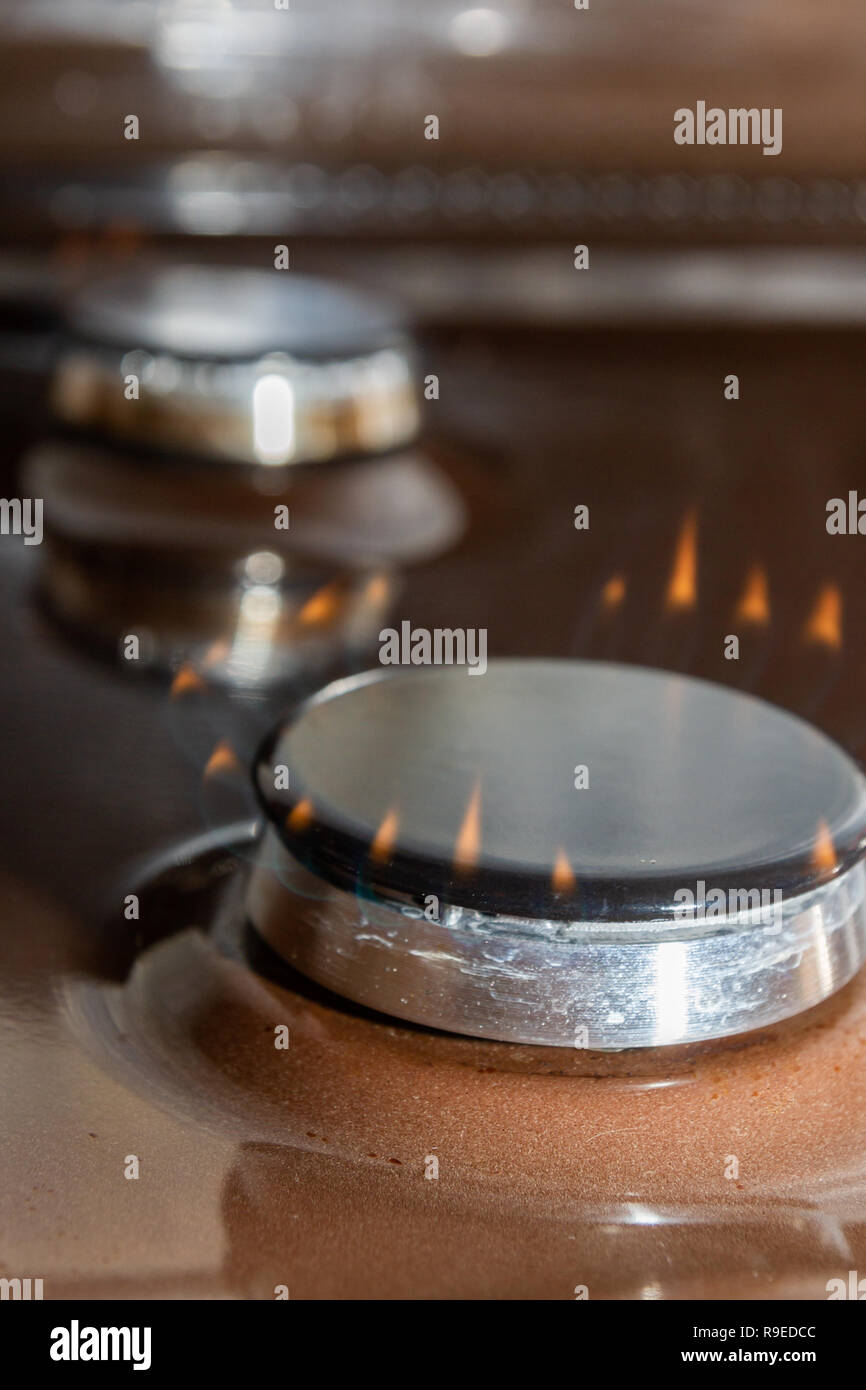 Gas stove with burning orange and blue fire on it Stock Photo Alamy