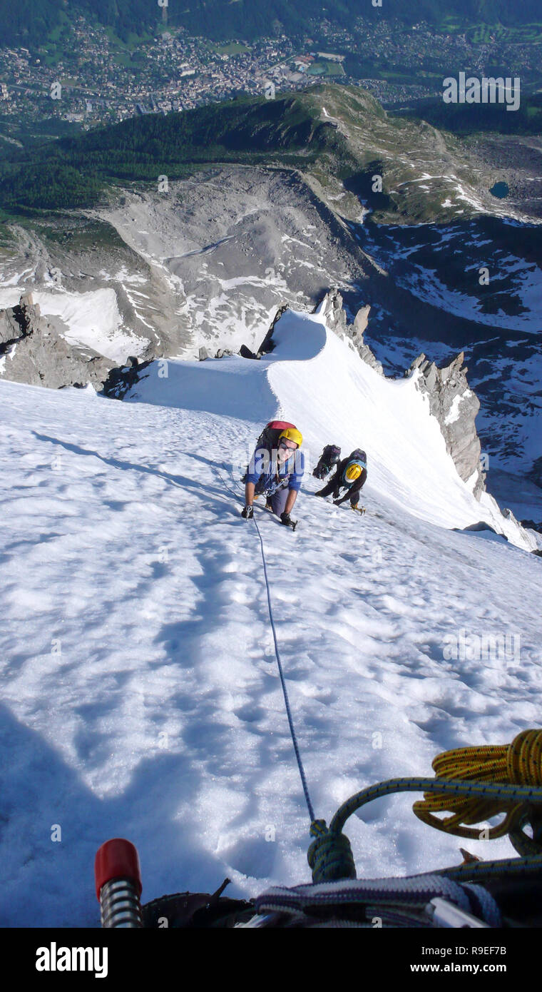 mountain climbers on a steep climbing route in the French Alps in