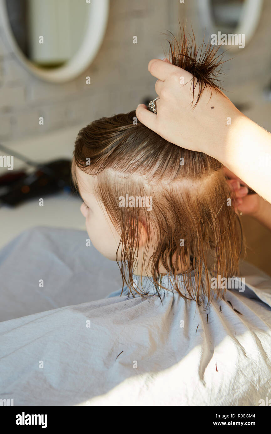 Hairdresser Making A Hair Style To Cute Little Girl Stock Photo