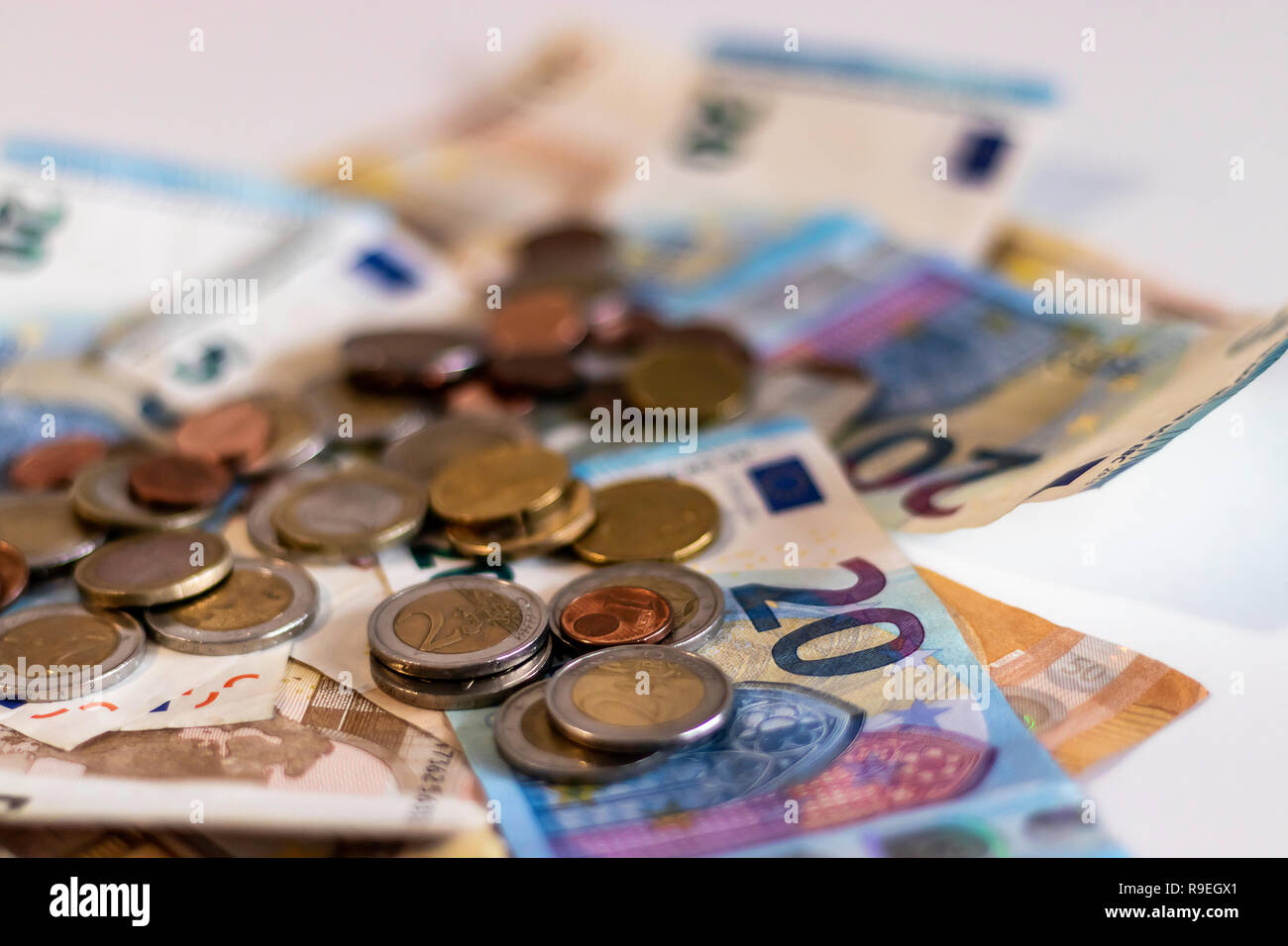Close up of euro banknotes and euro cents and coins on a white ...