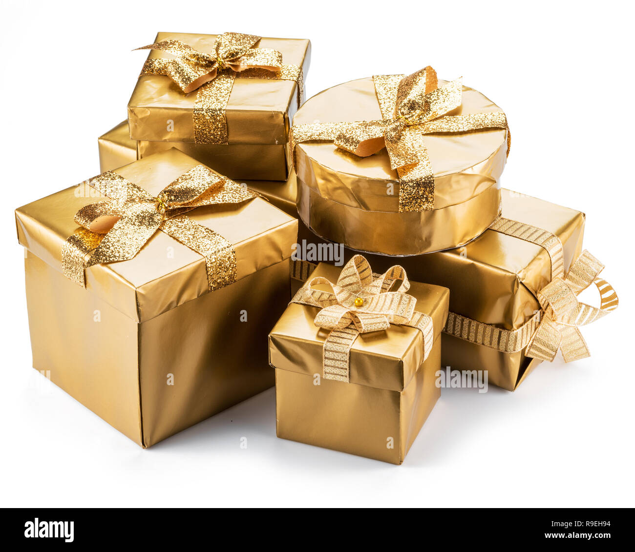 Golden gift boxes as a symbol of wishes and celebration on white background. Stock Photo