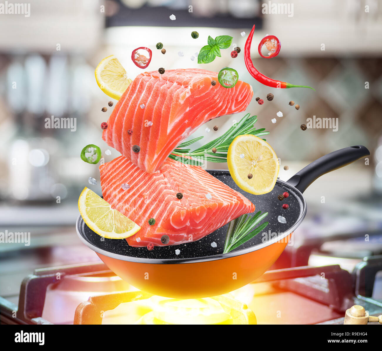 Grill pan with delicious salmon steaks on stove in kitchen Stock Photo -  Alamy