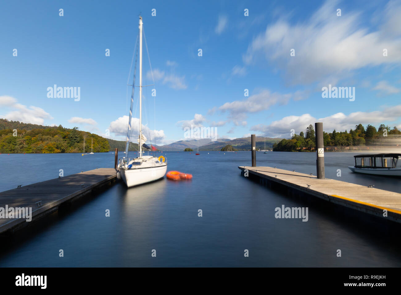 Sailboat docked to pier in Windermere, Lake District National Park, Cumbria, United Kingdom Stock Photo