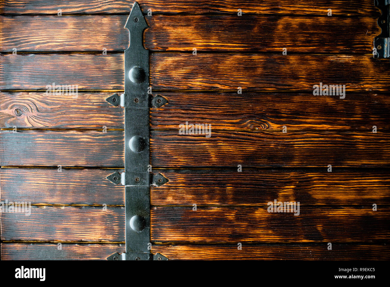 The texture of the tree with elements of forged metal. Wood texture. Brown board background, Natural background of brown boards wide and narrow Stock Photo