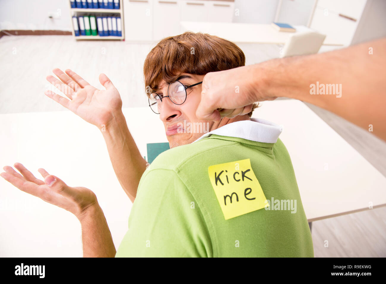 Office prank with kick me message on sticky note Stock Photo - Alamy