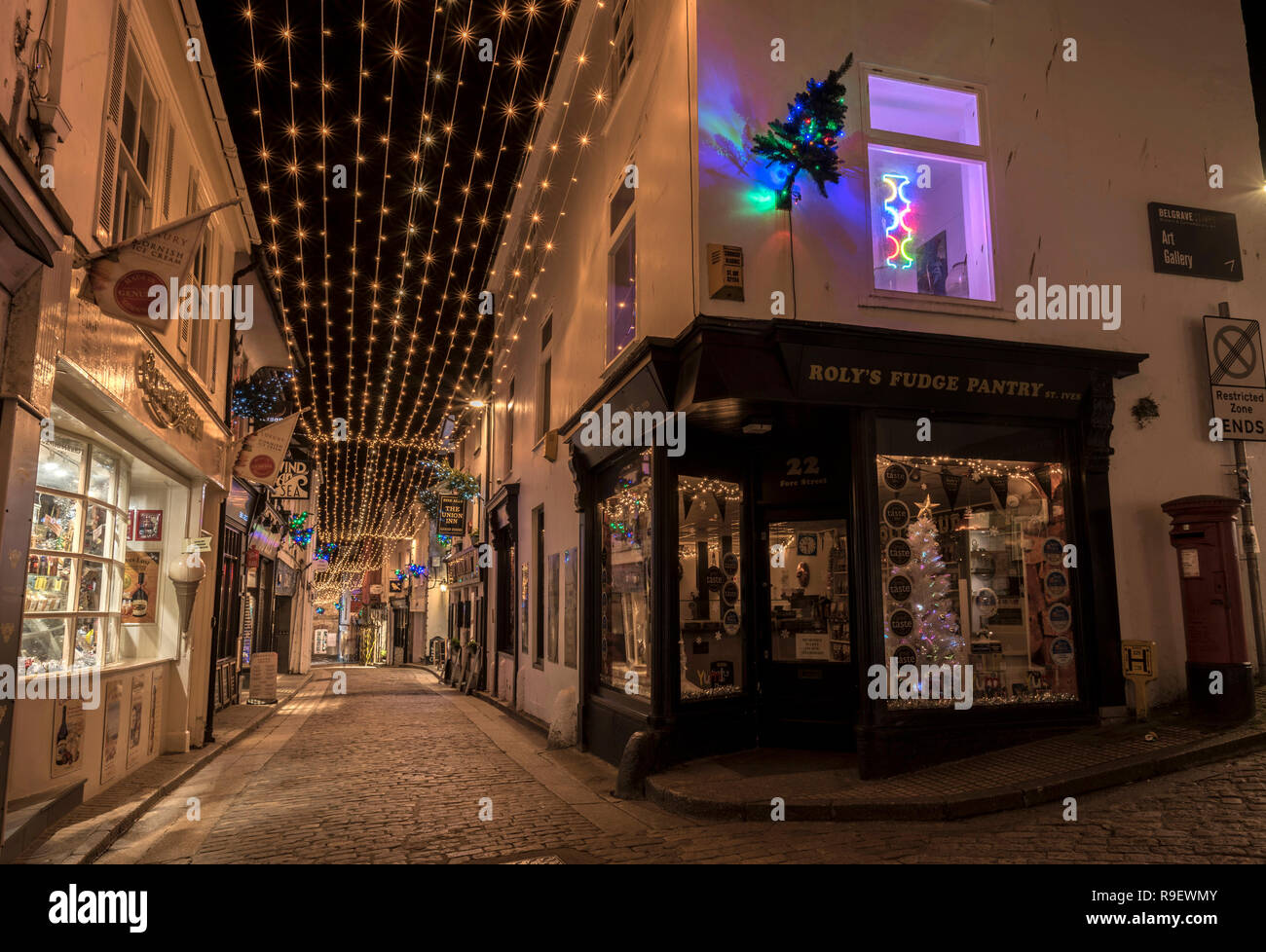 Pretty Christmas lights and Christmas trees in the cobbled streets of