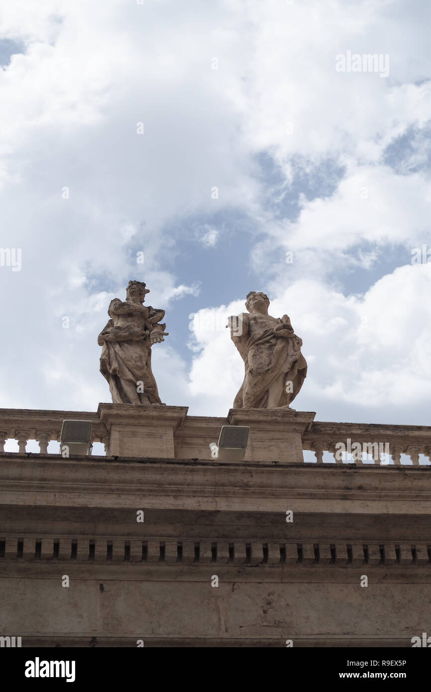 Two stone statues on a marble roof, St Peter's Basilica, Vatican Stock