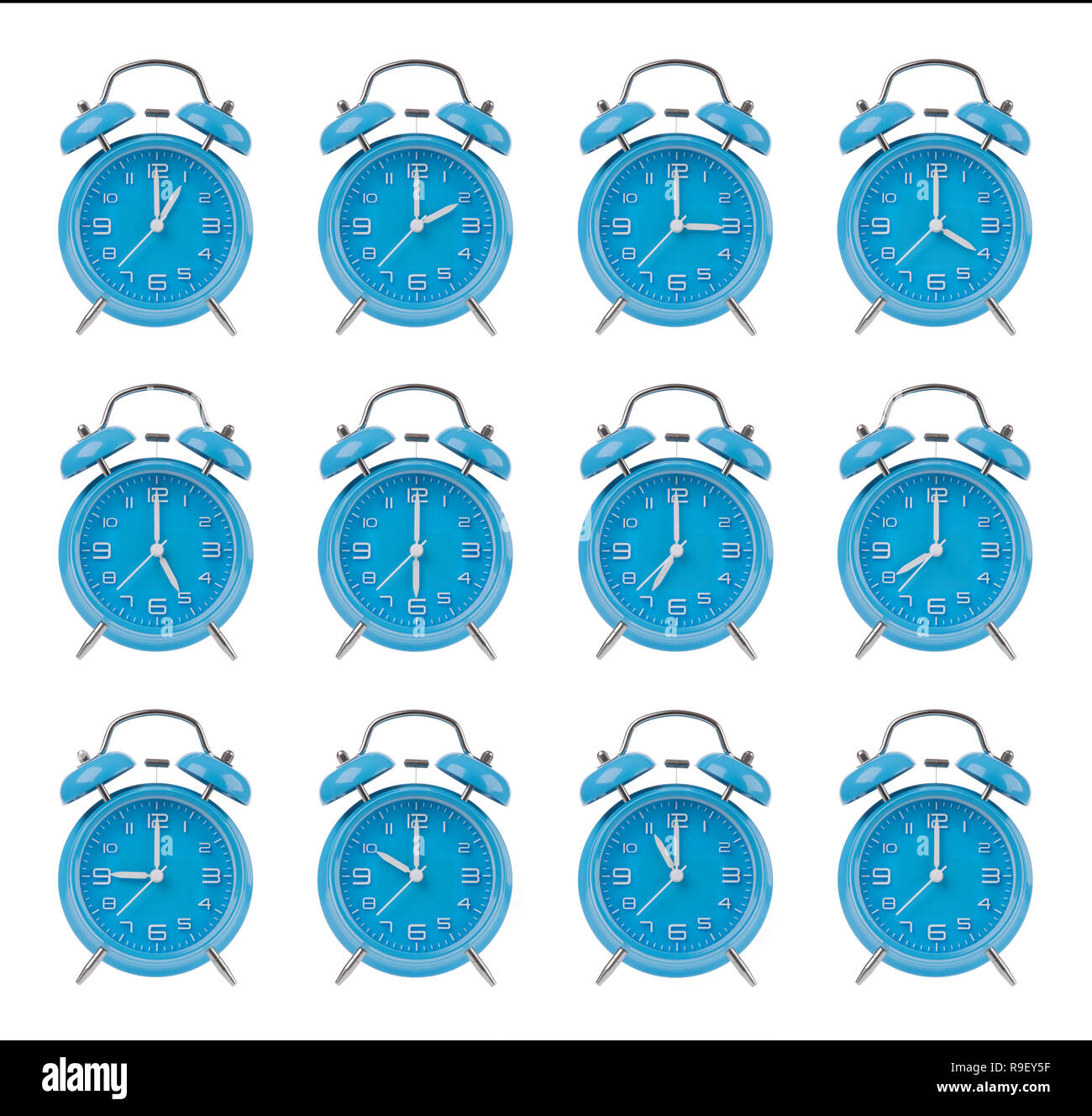 Twelve blue alarm clocks showing the top of each hour isolated on a white background Stock Photo