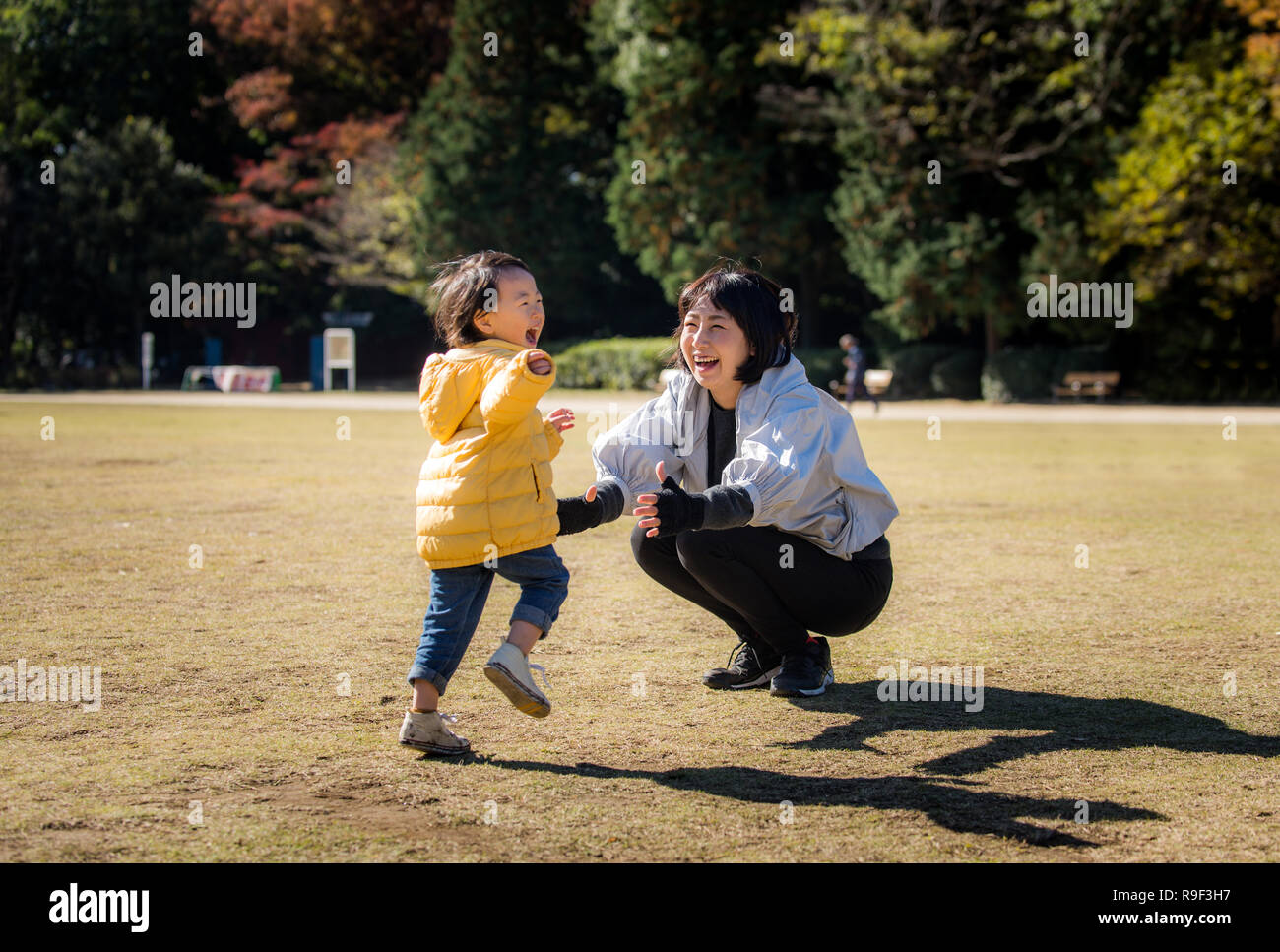 Happy and playful Japanese family in a park in Tokyo enjoying family time