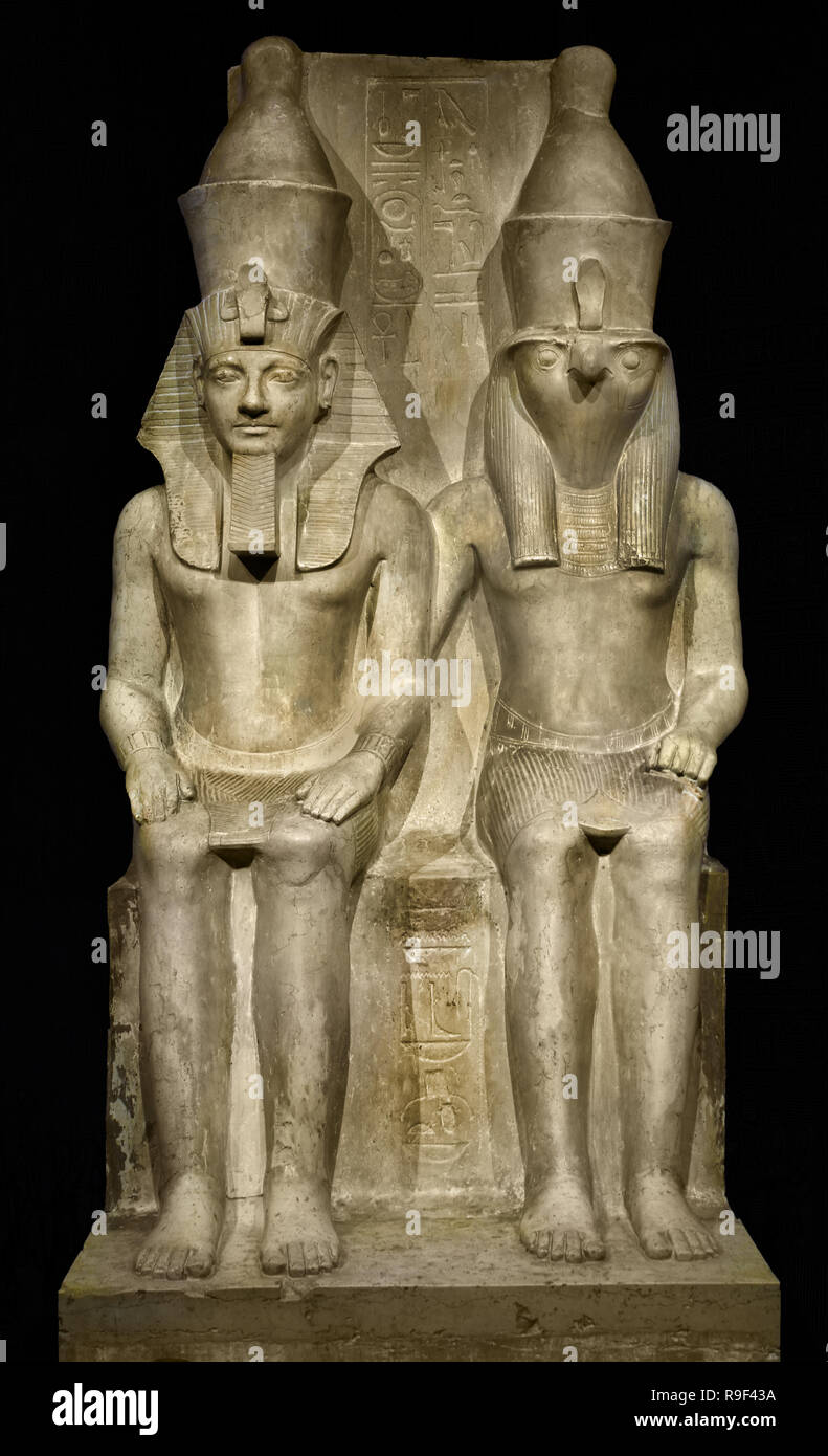 Image of Horus and Horemheb This temple image shows the god Horus and the Egyptian pharaoh Horemheb (1319-1305 BC) sitting side by side. Horus carries a falcon's head as a heavenly power. The king is the same size as the god, because according to the Egyptians he is equally powerful. He is the earthly appearance of Horus and thus himself a god. (1.52 meters of limestone Period: New Kingdom, 18th Dynasty (1319-1305 BC) Egypt, Egyptian. Stock Photo