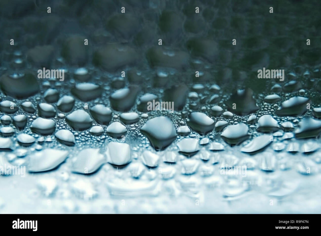 Drops of water on a window pane close-up Stock Photo