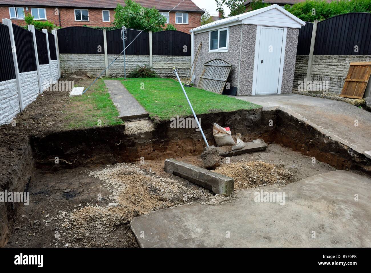 A UK garden being prepared for the laying of natural stone paving slabs