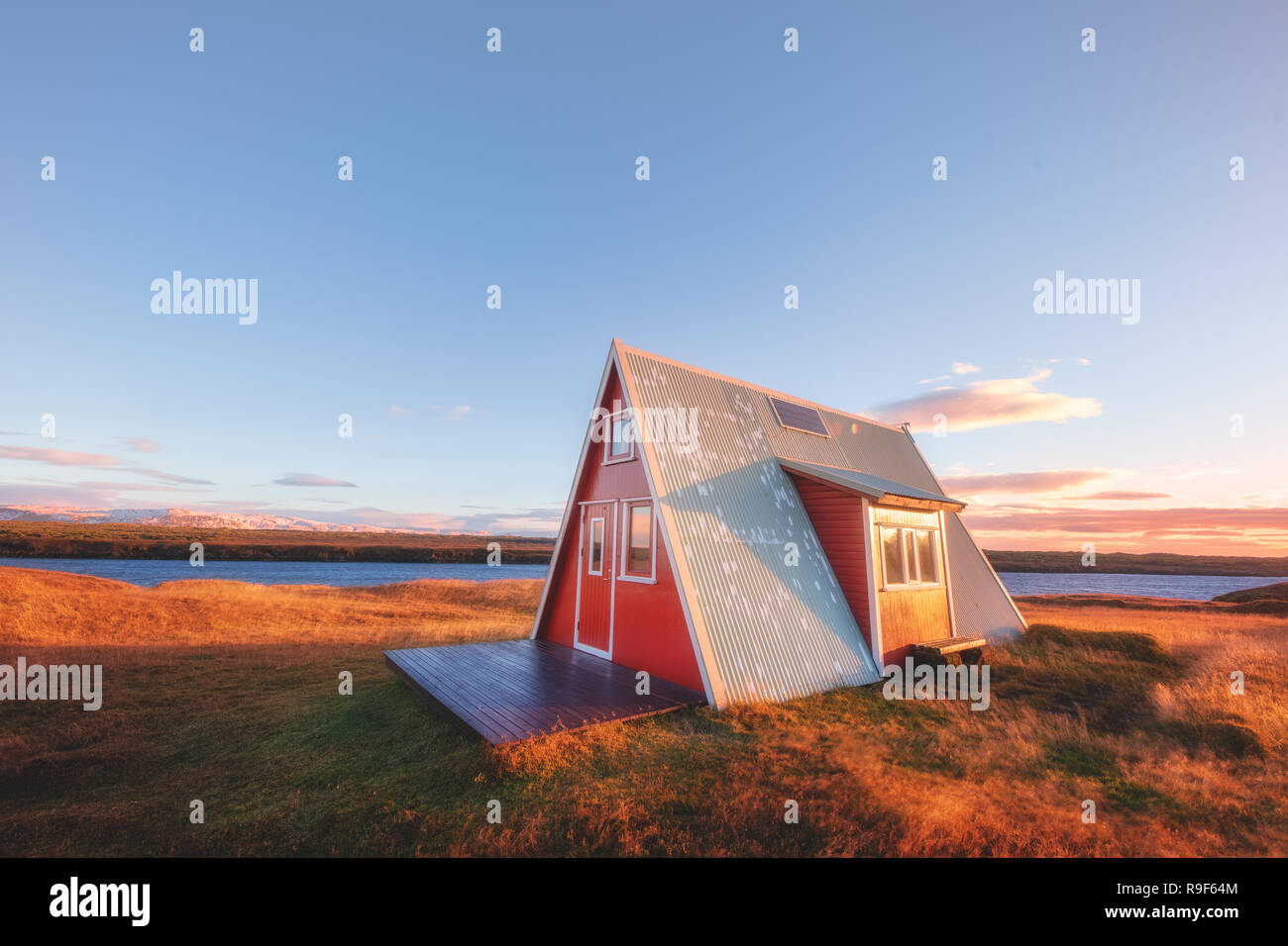 Cute triangle little house cabin red Iceland Icelandic Stock Photo