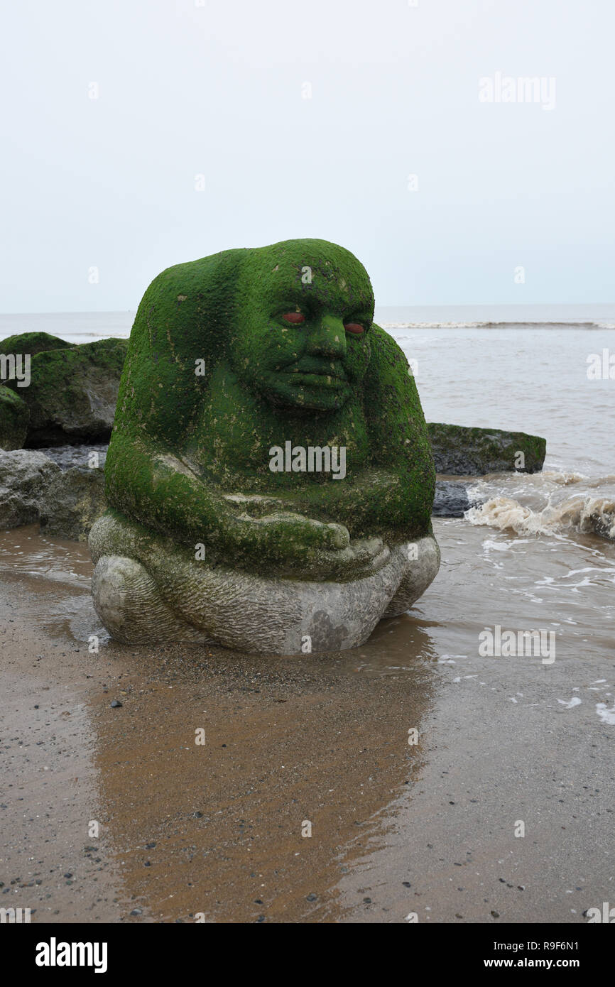 Stone Ogre sculpture showing algal growth, on cleveleys beach on the fylde coast in lancashire uk Stock Photo