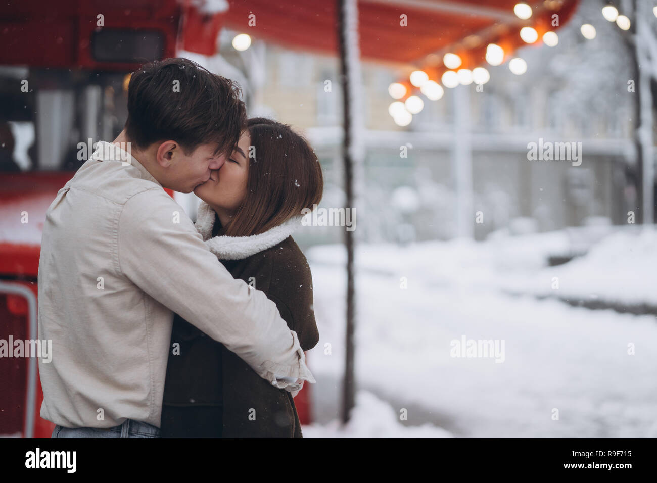 young guy and beautiful girl kiss in a snowy street Stock Photo - Alamy