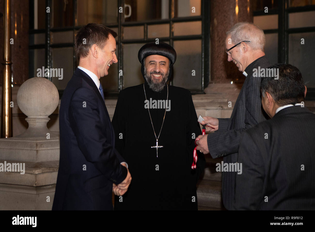 EMBARGOED TO 0001 MONDAY DECEMBER 24 Foreign Secretary Jeremy Hunt (left), The Archbishop of Canterbury Justin Welby (right) with Archbishop Angaelos of the Coptic Orthodox Church of Britain as they join other Christian leaders, dignitaries and politicians with survivors of Christian persecution at a meeting at the Foreign Office in central London. Stock Photo
