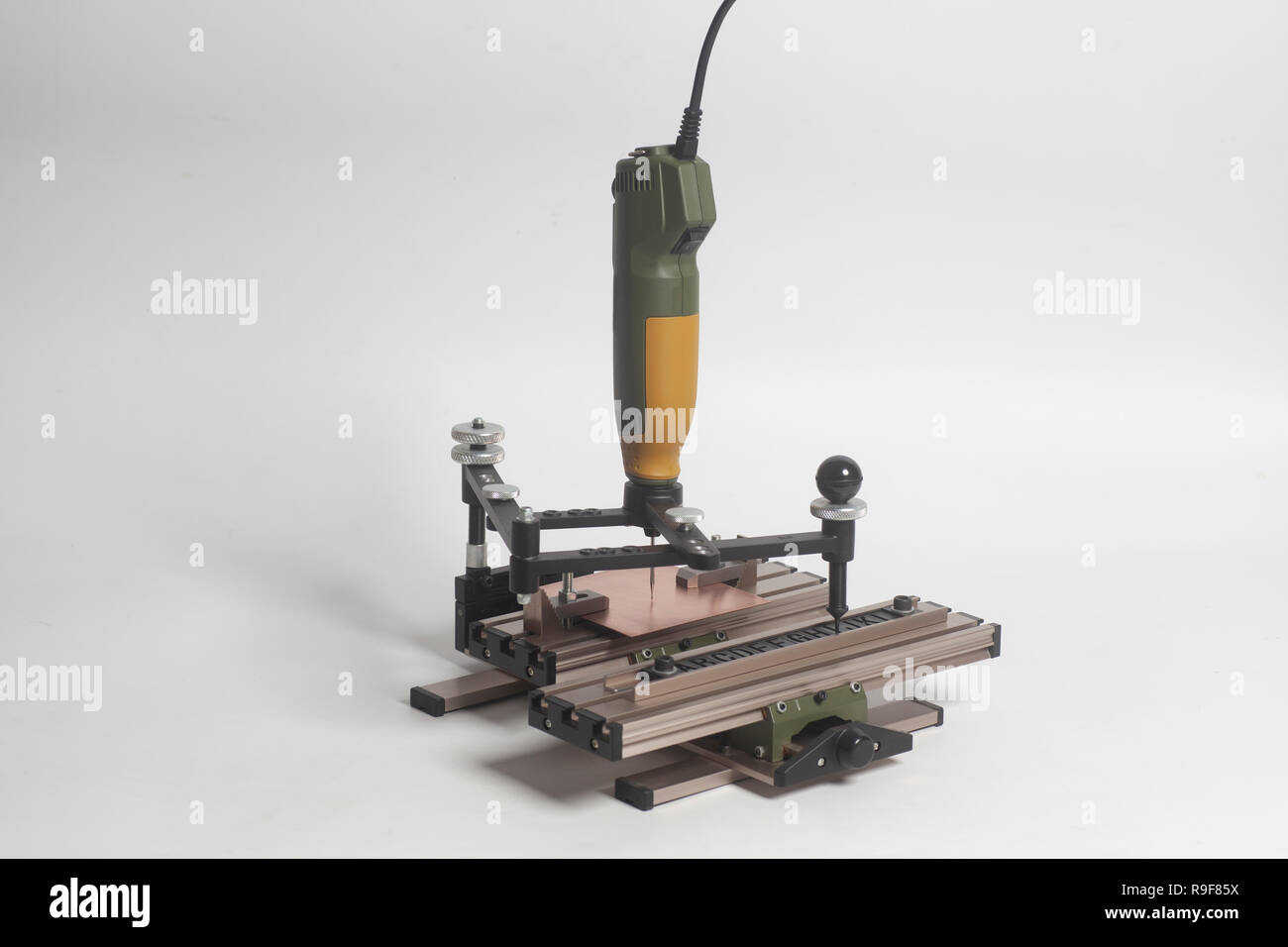 Engraving device pantograph with CNC engraver with letterpress alphabet on a white background Stock Photo