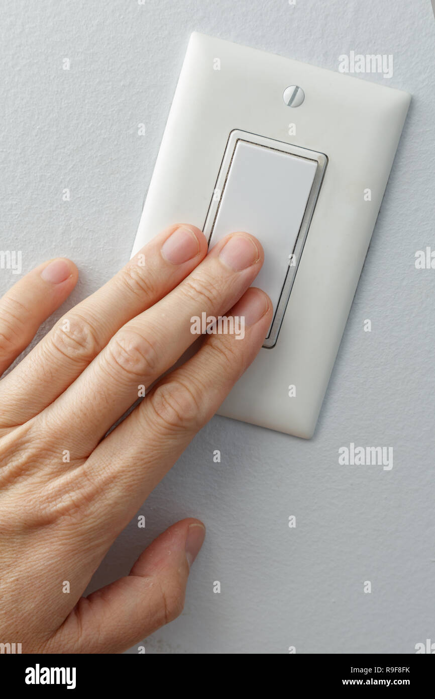 hand turning white light switch on or off Stock Photo Alamy