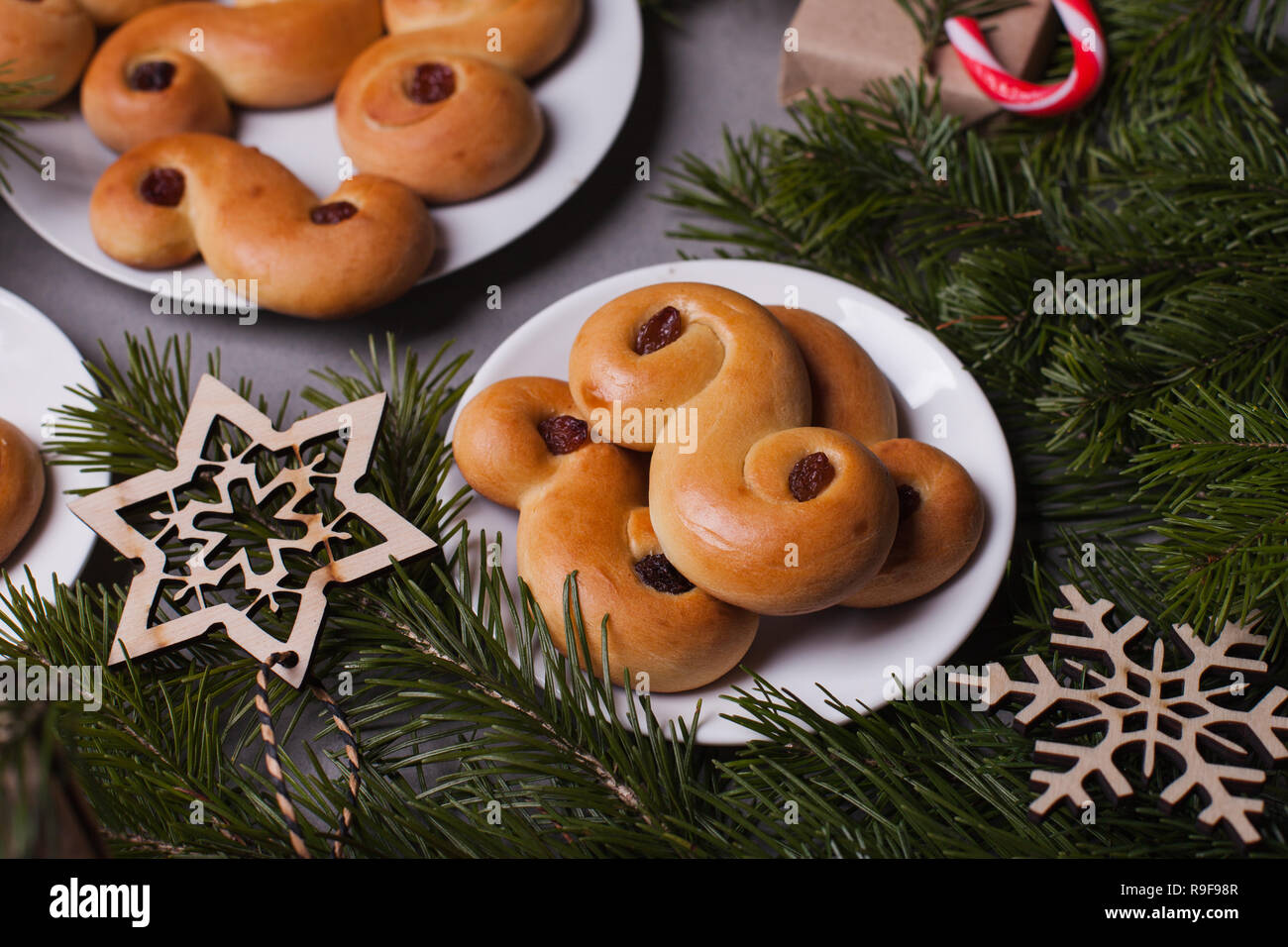Swedish christmas. Traditional swedish buns on cake stand in christmas setting. A saffron bun, in Swedish lussebulle or lussekatt Stock Photo