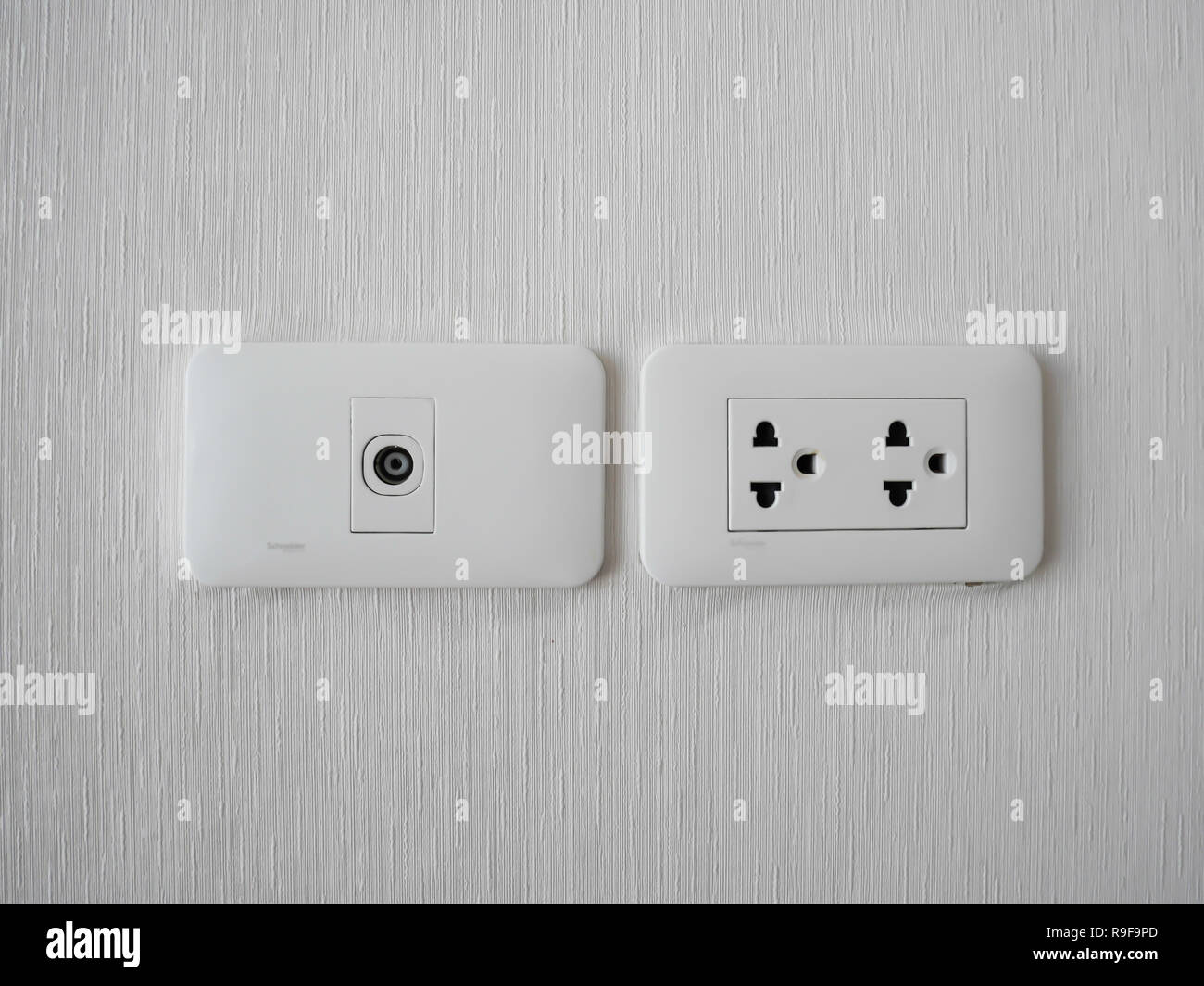 Plug Into Electricity Socket the power outlets on wall. sockets plug outlets with 220 volts (220V) AC style. White electrical outlet on wall in th Stock Photo - Alamy