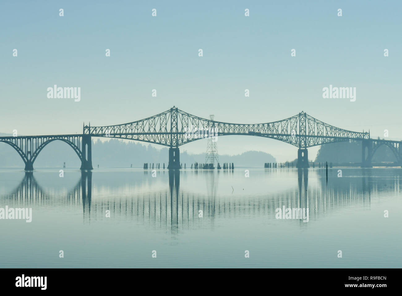 Views of a bridge over the Coos River bay at its mouth next to the Oregon Dunes, USA Stock Photo