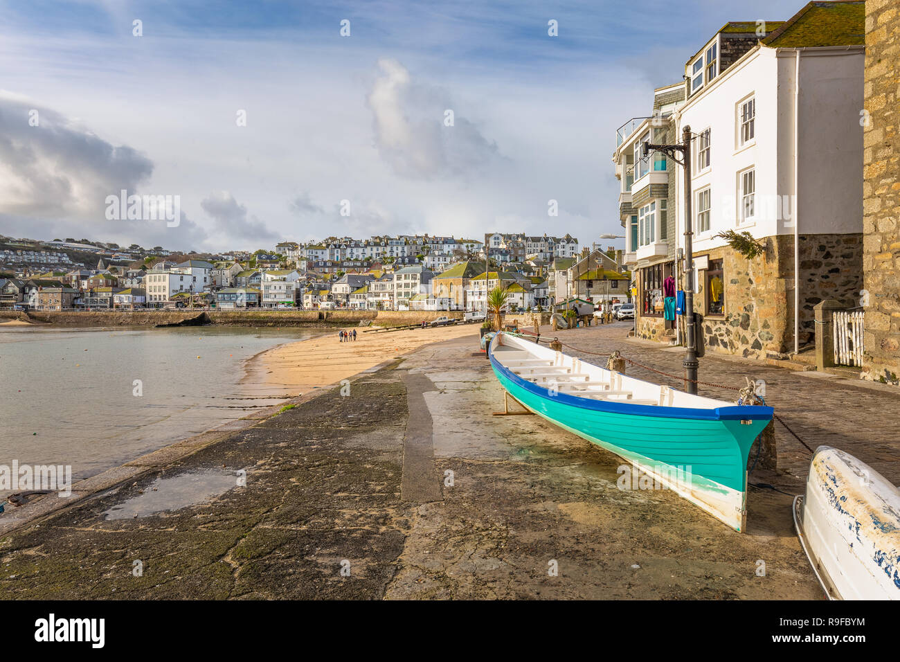 Cornish pilot gig, with view over the pretty fishing harbour of St Ives, on the north Cornwall coast. Stock Photo