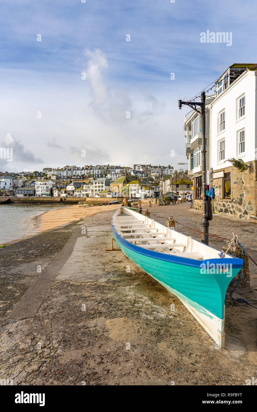 Freshly painted Cornish pilot gig, with view over the pretty fishing harbour of St Ives, on the north Cornwall coast. Stock Photo