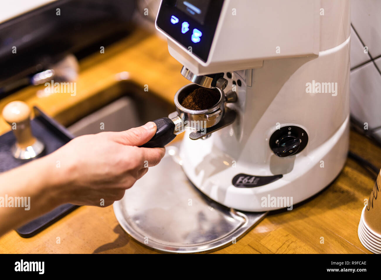 Freshly coffee powder in coffee holder from coffee maker machine Grinder  Stock Photo - Alamy