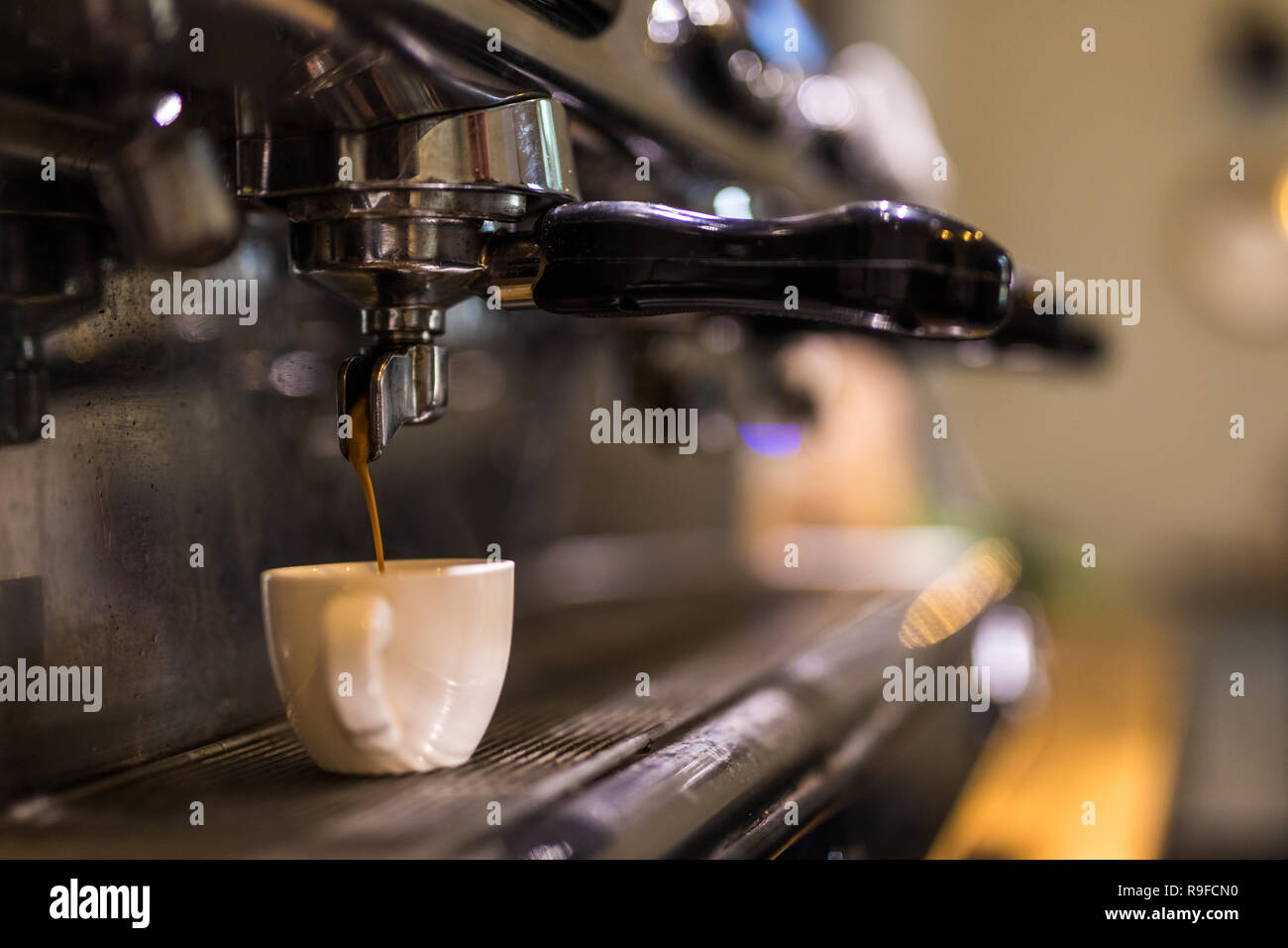 Coffee extraction from professional coffee machine in cafe Stock Photo