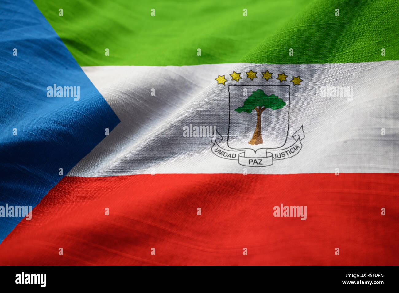 Closeup of Ruffled Equatorial Guinea Flag, Equatorial Guinea Flag Blowing in Wind Stock Photo