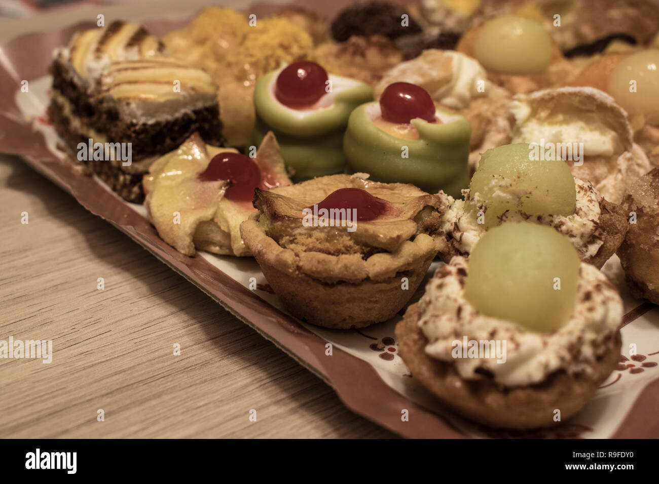 Different types of fresh and delicious little cakes Stock Photo