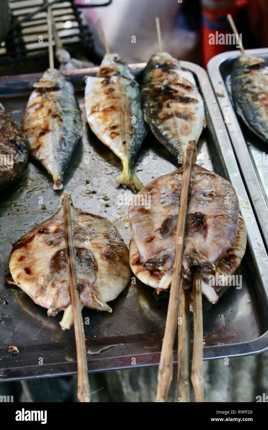 Grilled fish and stingray on sticks sold as snacks at a Cambodian crab market Stock Photo