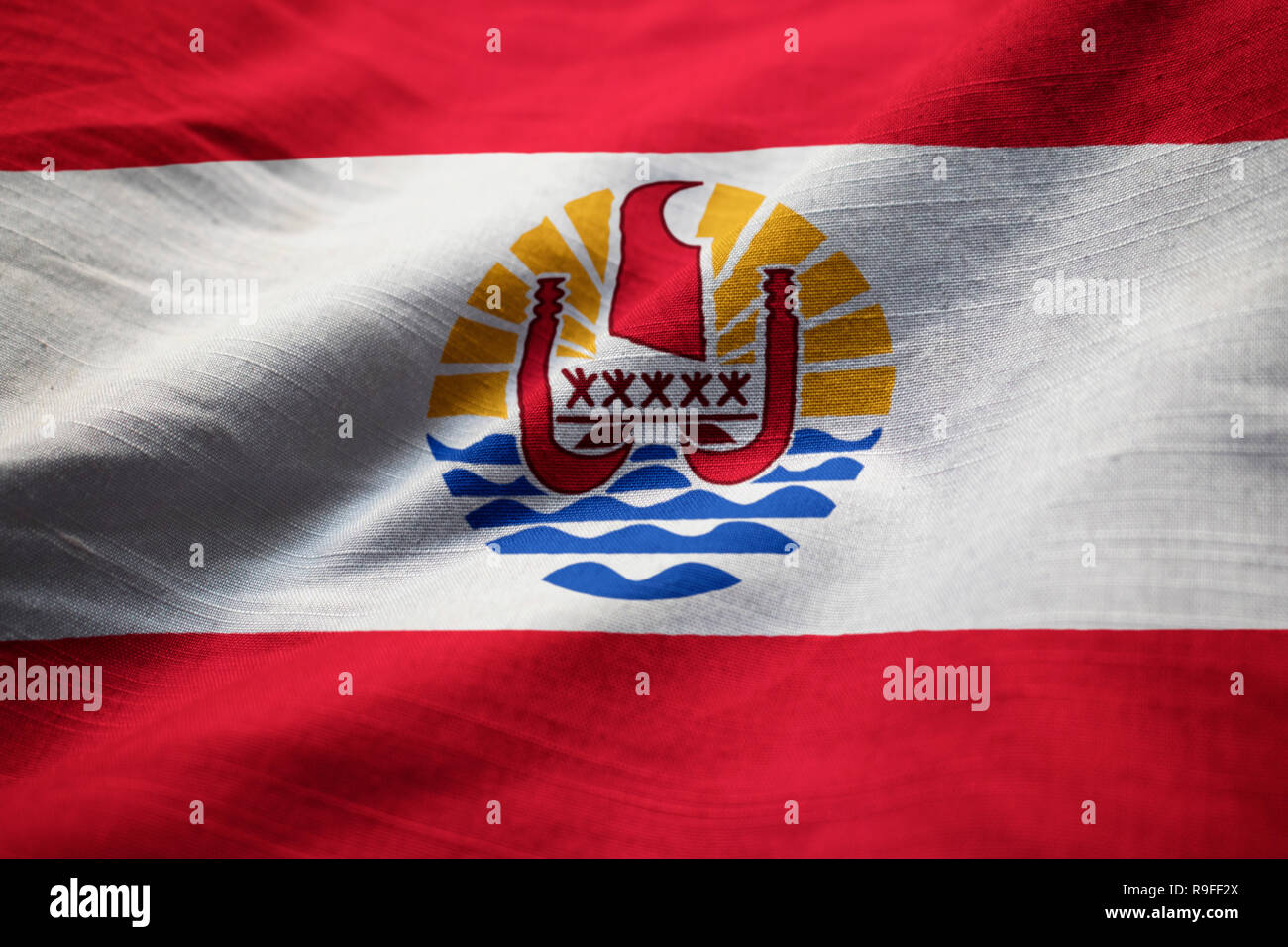 Closeup of Ruffled French Polynesia Flag, French Polynesia Flag Blowing in Wind Stock Photo