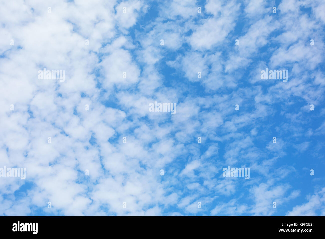 White fluffy clouds in blue sky background Stock Photo