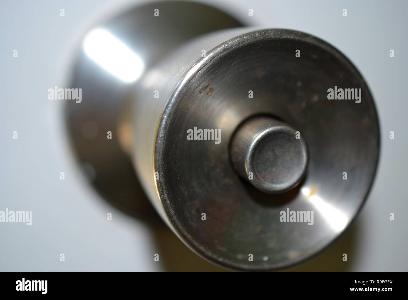 Well worn push button door knob closeup Stock Photo