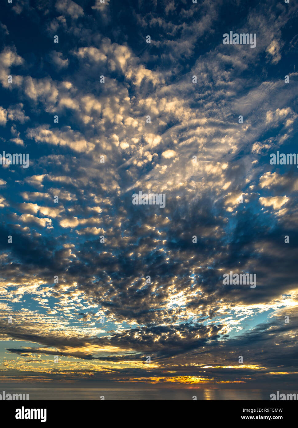 Dramatic clouds in Sunset sky Trevalgan hill St.ives Cornwall UK Portrait Stock Photo