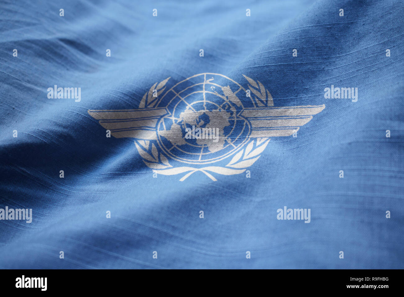 Closeup of Ruffled International Civil Aviation Organization Flag, ICAO Flag Blowing in Wind Stock Photo