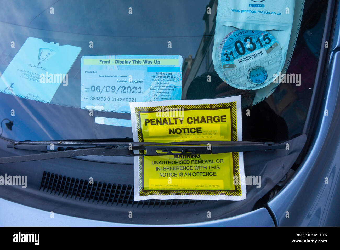 Penalty Charge Notice on a car that has a disabled badge failed to display a valid  paid parking ticket in Whitby North Yorkshire England UK Stock Photo