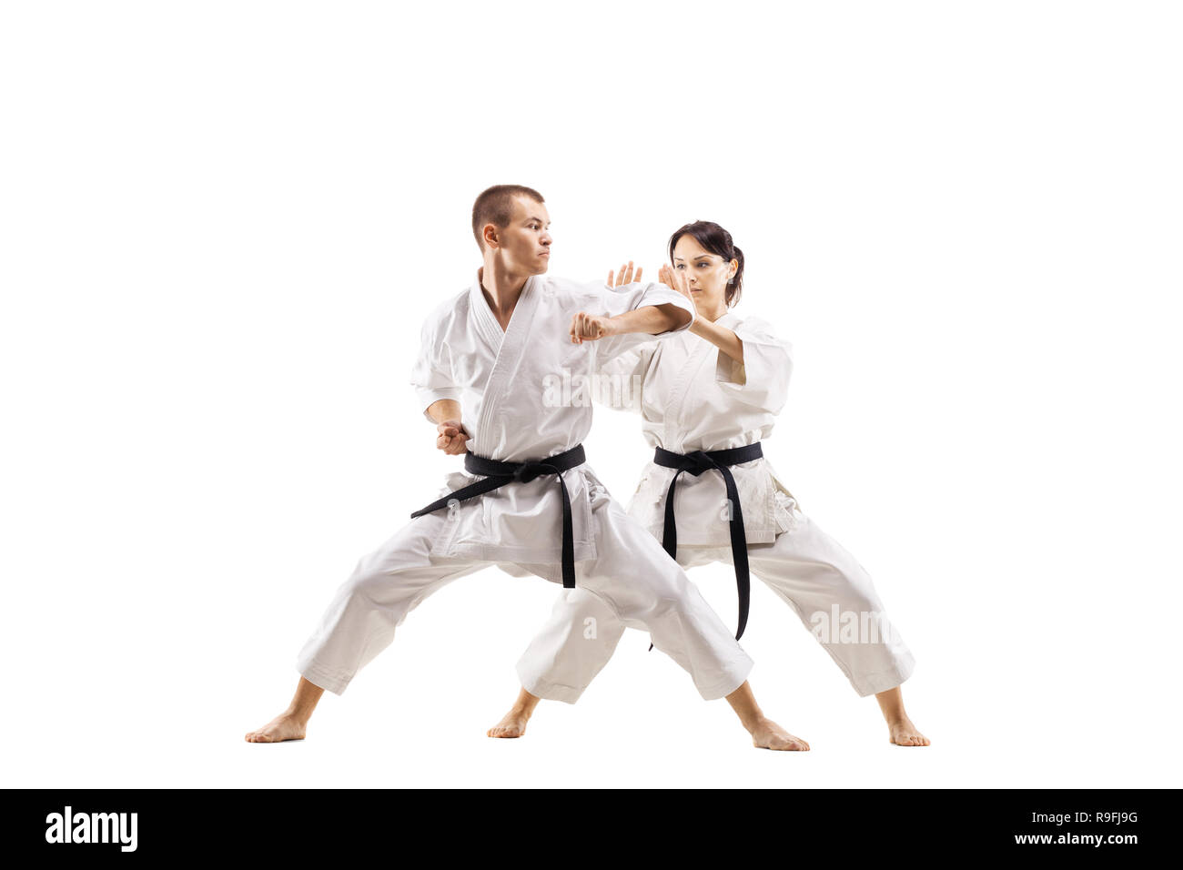 karate girl and boy fighting against white background Stock Photo Alamy