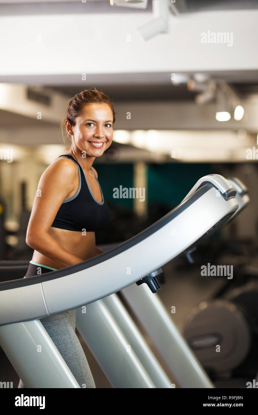 happy girl walking on a treadmill Stock Photo Alamy