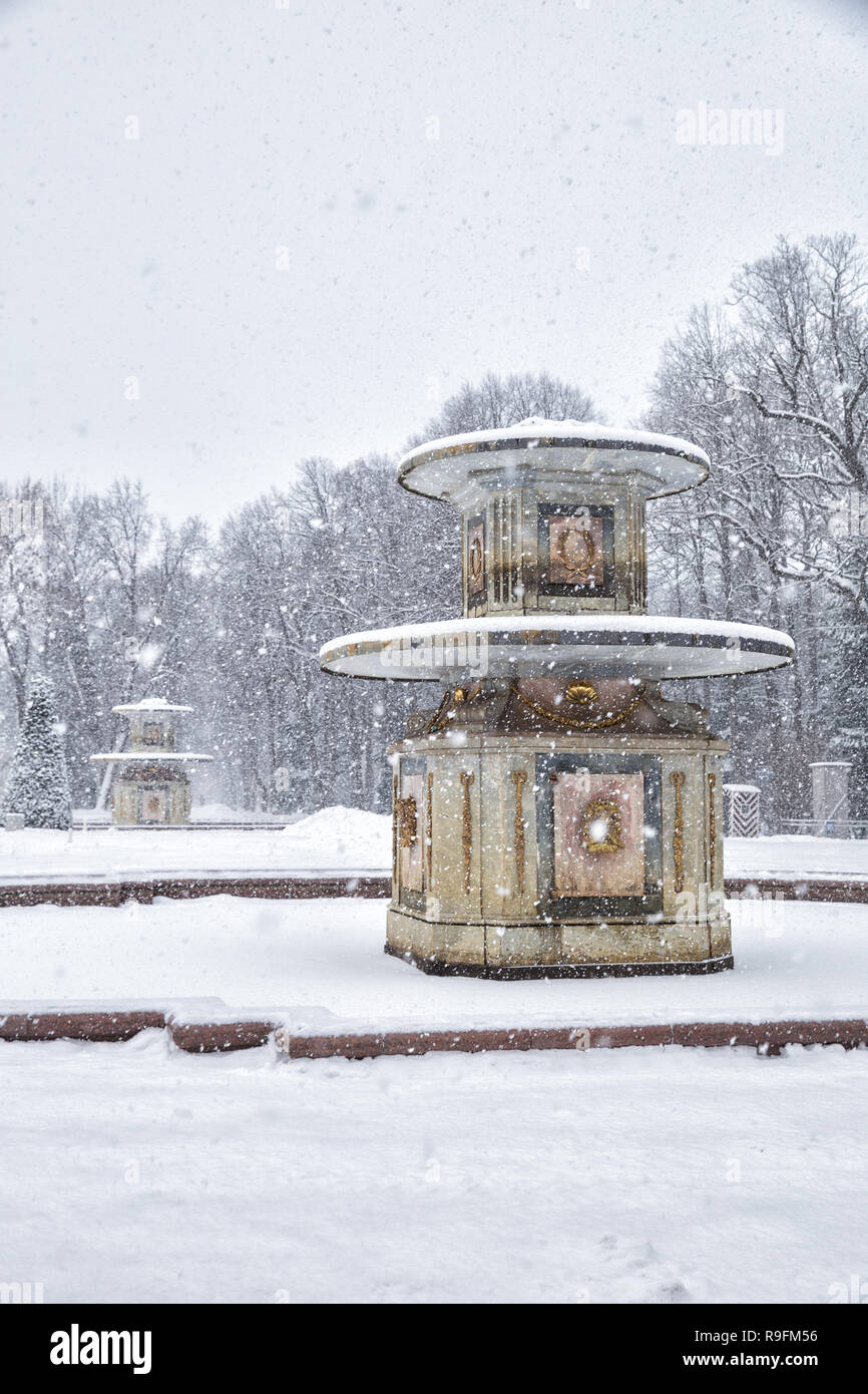 SAINT PETERSBURG, RUSSIA - JANUARY 22, 2018: Peterhof in winter.  Heavy snowfall in  Lower Park, Roman fountains covered with snow Stock Photo