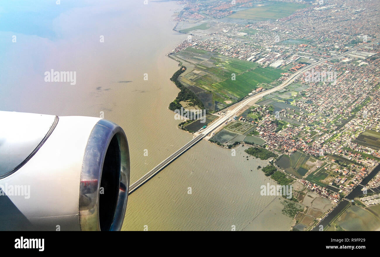 Suramadu Bridge which connecting Surabaya and the island of Madura, seen from airplane window. Stock Photo