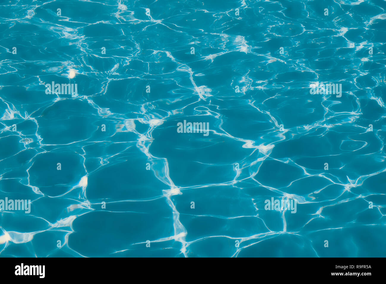 Blue and bright ripple clean water surface in swimming pool with sun ...