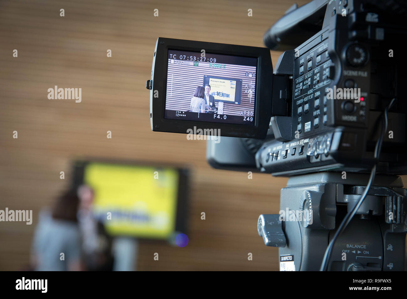 A video camera in use at a business conference Stock Photo