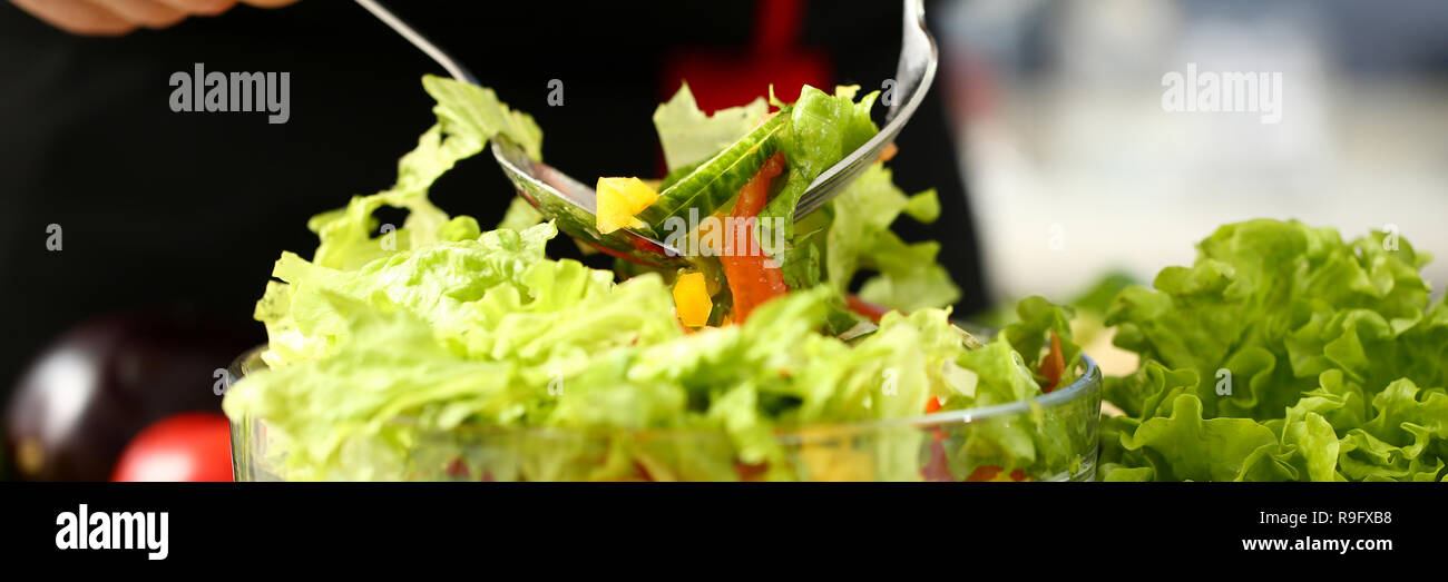 Cook holds fork in hand and mixes Stock Photo - Alamy
