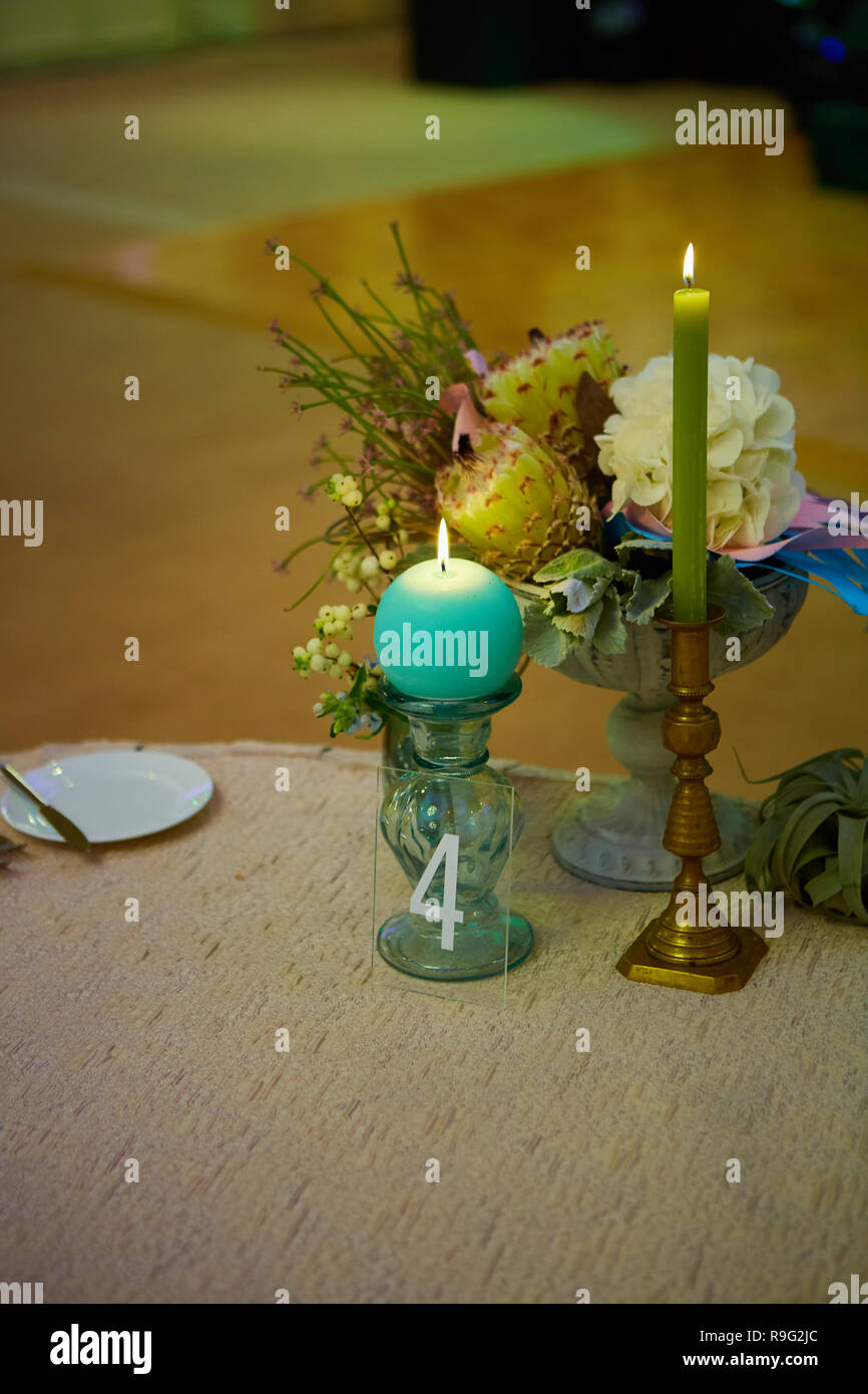 Elegant wedding guest table set for an event with candles lit Stock