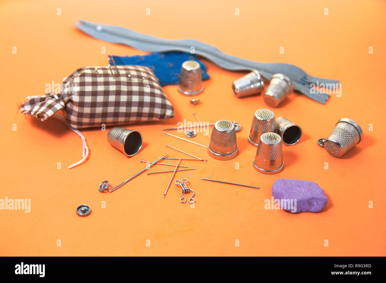 Some elements necessary for sewing such as sewing needles, thimbles among others Stock Photo