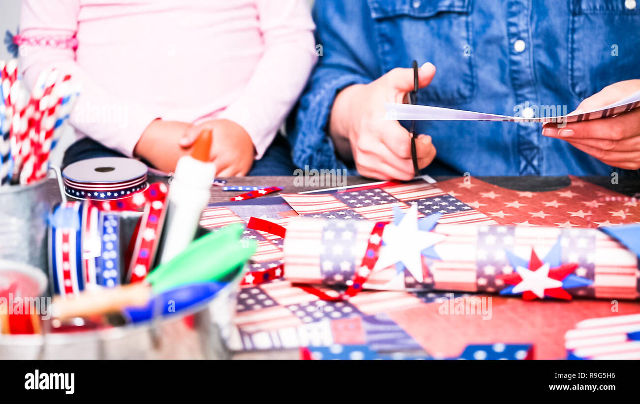 Step by step. Mother and daughter making paper firecrackers for July ...