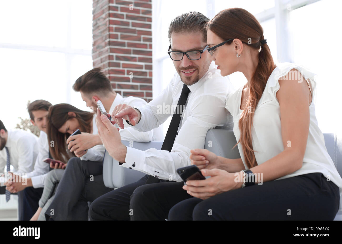 Someone Using Something business colleagues use a smartphone and discussing something Stock ...